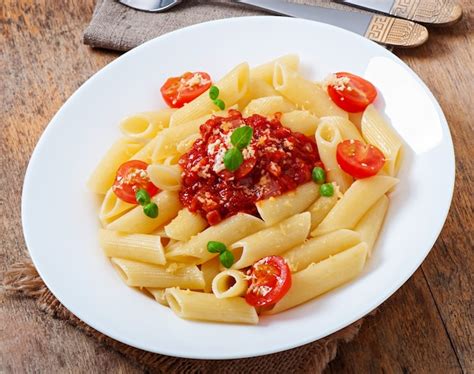 Free Photo | Penne pasta with bolognese sauce, parmesan cheese and basil