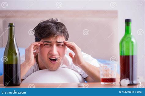 Man Alcoholic Drinking In Bed Going Through Break Up Depression Stock