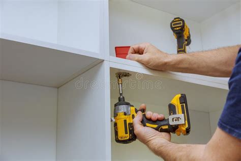 Modern Fixing Cabinet Door Hinge Adjustment on Kitchen Cabinets Stock ...