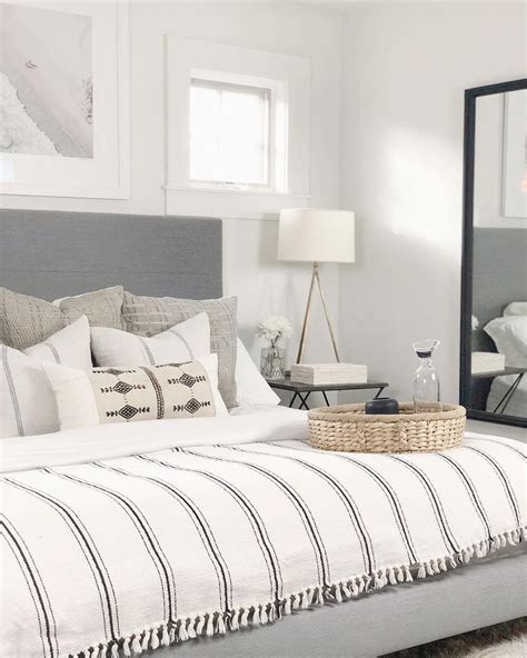 Coastal Bedroom Design With White Bedding And Upholstered Headboard