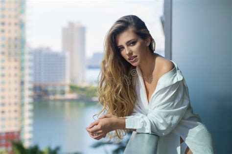 Woman On The Balcony Enjoying City View Attractive Girl With Long Blonde Hair In Shirt On