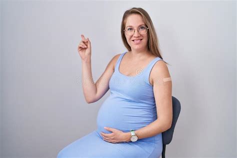 Young Pregnant Woman Wearing Band Aid For Vaccine Injection Smiling