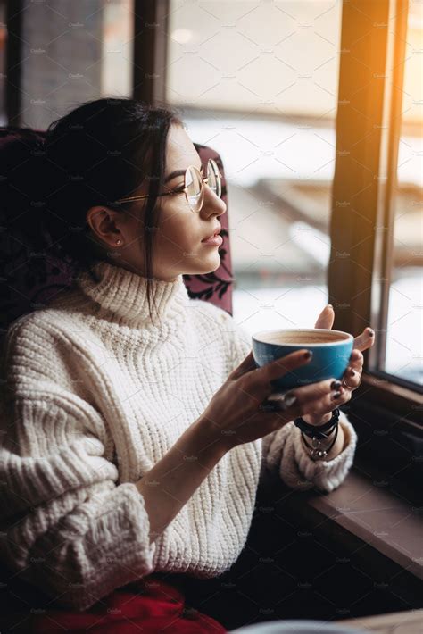 Girl Enjoying Flavor Of Coffee While Relaxing At Coffee Shop Featuring