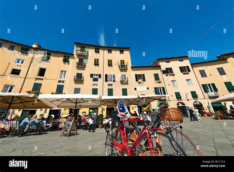 Tourists Visit The Ancient Town Square Piazza Dell Anfiteatro