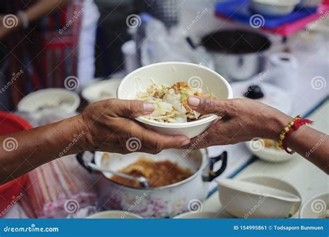 Hands Of Volunteers Serves Free Food To The Poor And Needy In The City