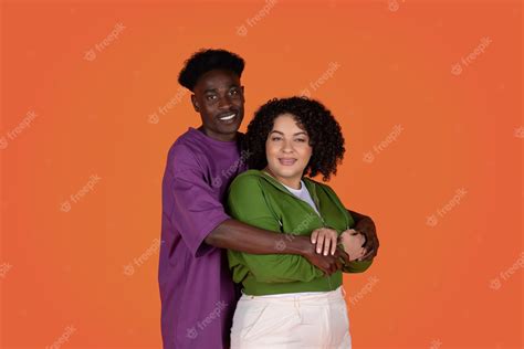 Premium Photo Happy Loving Interracial Couple Posing On Colorful