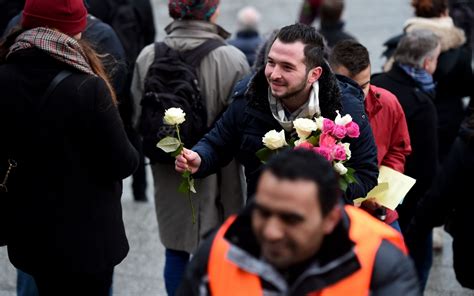 Germany Refugees Hand Out Flowers To Women In Protest Against New Year