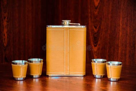 Metal Flask Trimmed Leather And Four Metallic Sturdy Shot Glasses