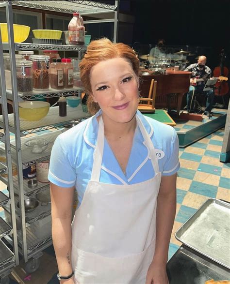 A Woman Standing In Front Of A Counter With Some Food On It And She Is