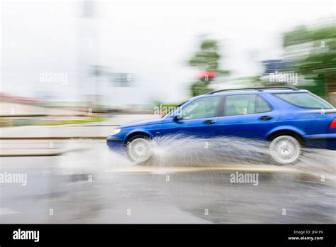 Car Splashing Water On Road Stock Photo Alamy