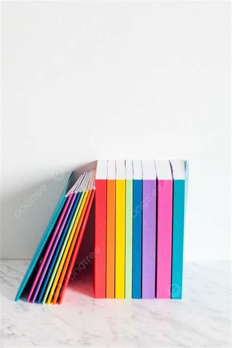 Colorful Books Are Outlined In The Colors Of The Rainbow Stacked Of The Books On A Shelf Near ...