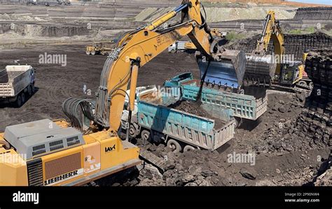 Excavators Working On Huge Mining Site Loading The Trucks Trucks