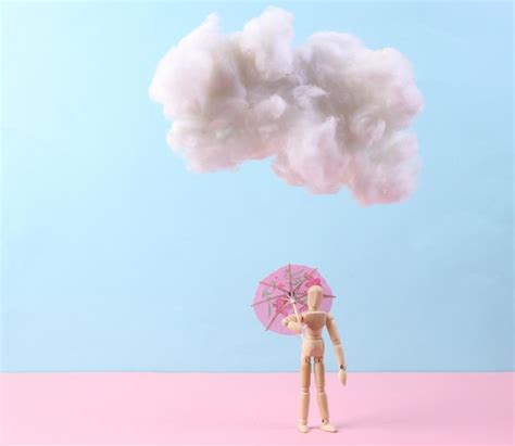 Premium Photo Puppet With Umbrella And Cloud On A Bluepink Background