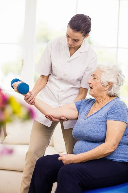 Premium Photo Physiotherapist Taking Care Of Sick Elderly Patient At Home