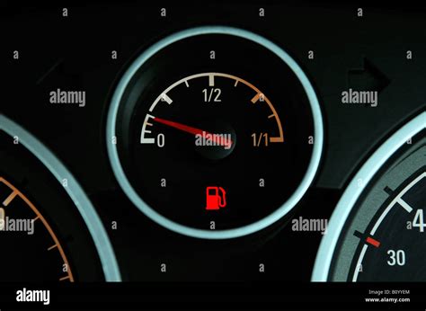 A BRITISH CAR FUEL GAUGE SHOWING LOW FUEL WITH RED WARNING LIGHT,UK Stock Photo - Alamy