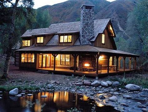 A Large Cabin Style House Sitting On The Side Of A River