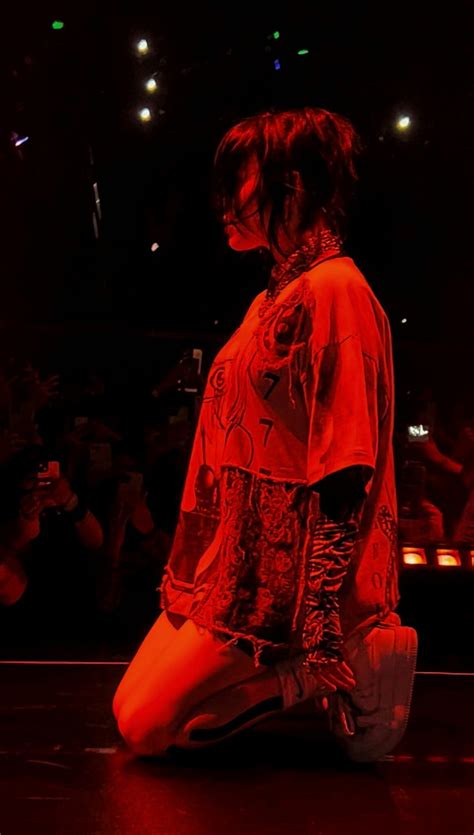 a person sitting on the ground in front of a crowd