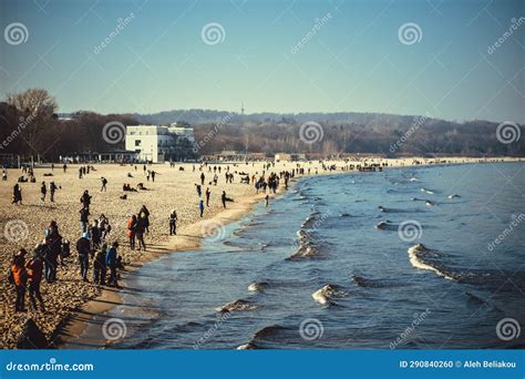 People Walking Along The Seashore With Waves Stock Photo Image Of