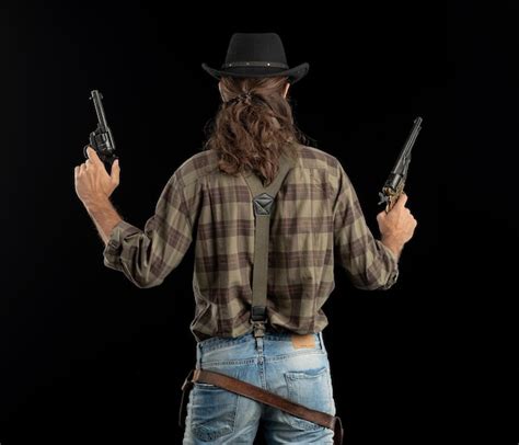 Premium Photo Midsection Of Man Holding Hat Against Black Background