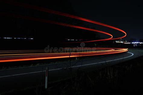 Long Exposure of Light Trails Captured Along a Transportation Route at ...