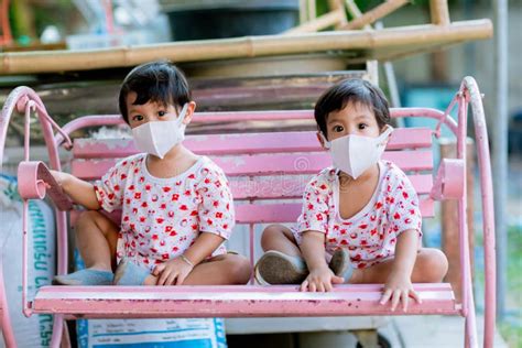 Child Wearing a Protective Face Mask on a City Street with Air ...