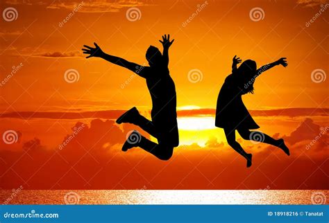 Silhouettes Of Couple Jumping On Sunset Stock Photo Image Of Black