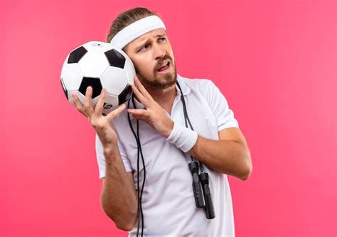 Free Photo Confused Young Handsome Sporty Man Wearing Headband And