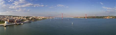 Aerial Panoramic View Of The City Of Lisbon With Sail Boats On The