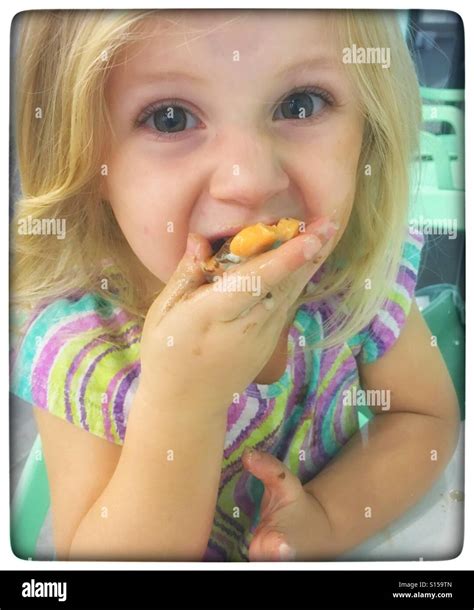 Girl Eating Yogurt Stock Photo Alamy