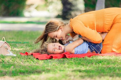 Premium Photo Cheerful Mother And Daughter Enjoying At Public Park