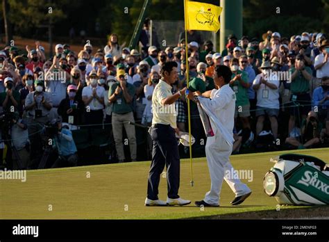 Hideki Matsuyama Of Japan Hugs His Caddie Shota Hayafuji After