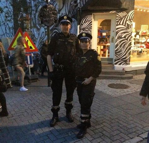 Two Police Officers Standing Next To Each Other