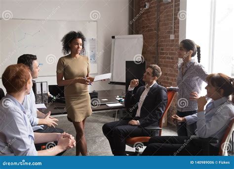 Serious Female African Coach Mentor Speaking At Diverse Team Meeting