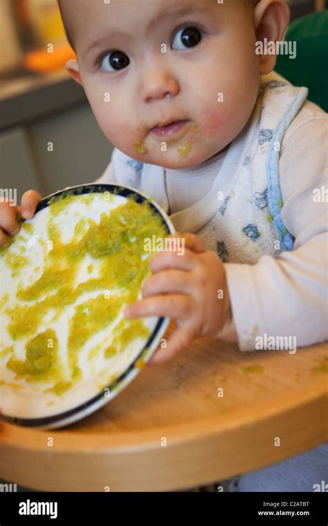 Baby Girl Making A Mess With Her Food Stock Photo Alamy