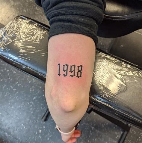 A Person With A Tattoo On Their Arm That Says 99 9 And Has The Word 99