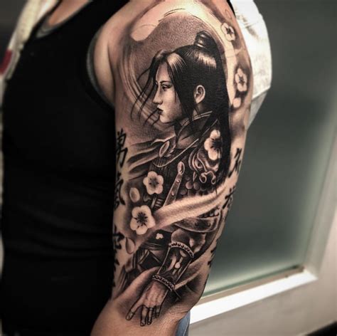 A Female Samurai Displayed In Black And Grey Realistic Tattoo Work