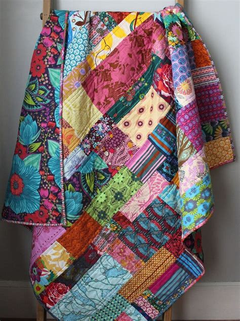 A Multicolored Patchwork Quilt Hanging On A Clothes Rack