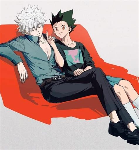 Two Anime Characters Are Sitting On A Red Chair