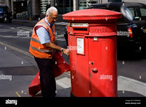 A Postman Is Collecting Mail In City District London Stock Photo Alamy