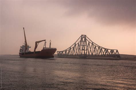 Cargo Ship Passing Alongside El Ferdan Swing Bridge On Suez Canal By