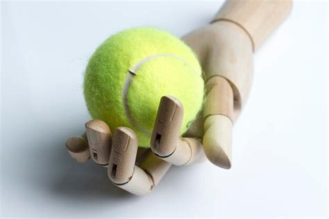 Premium Photo Wooden Hand Holding A Tennis Ball