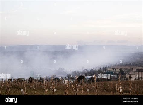 A Residential Area Covered With Smoke From A Nearby Gioto Garbage Dump