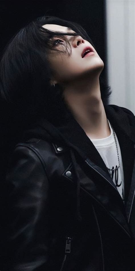 A Woman With Black Hair Wearing A Leather Jacket