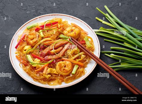 Singapore Mei Fun In White Plate On Dark Slate Background Singapore Noodles Is Chinese Cuisine