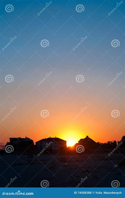 Sunset Behind The Houses And Clouds Stock Photo Image Of Line Field