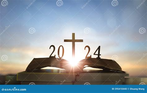 2024 New Year And Cross Of Jesus Christ On Open Holy Bible With Sunrise