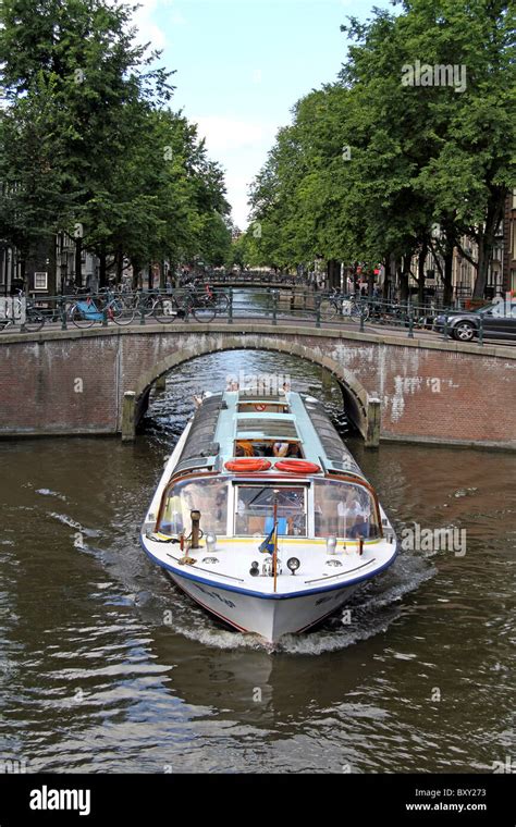 Bridge And Tourist Boat On The Canal At Leidse Gracht In Amsterdam