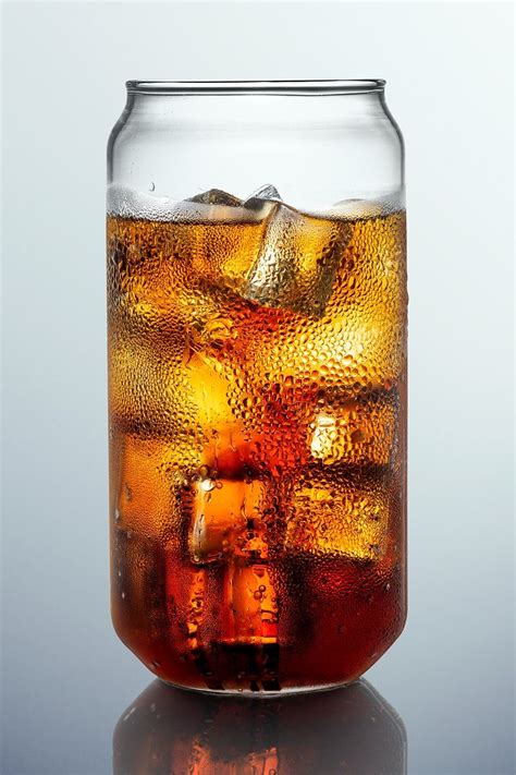 Download Premium Psd Image Of Cold Carbonated Drink Over Ice Cubes In A Can Shaped Glass By