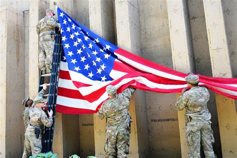 U S Troops Hang An American Flag Inside The Compound Barrier Wall In