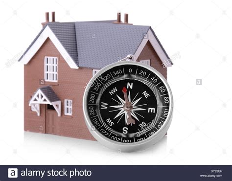 Concept Of Looking For A House A Compass With Small House Isolated On A Whits Background Stock